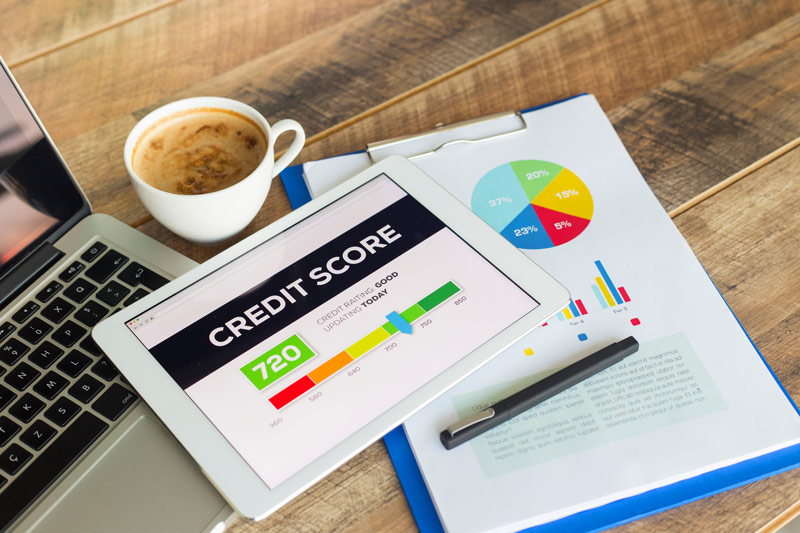 Credit score on a tablet by a cup of coffe
