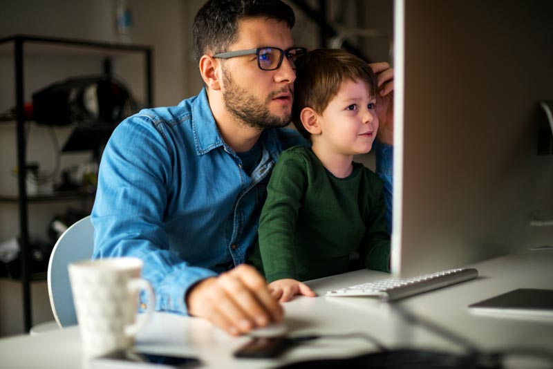 Father with his son on a computer