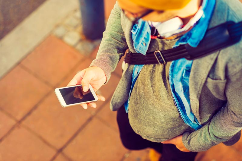 Guy glancing down at his mobile phone