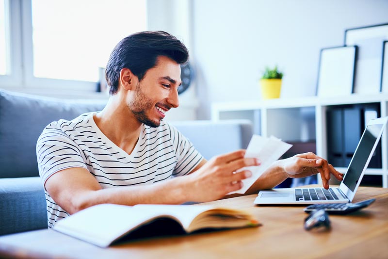 Guy in a striped t-shirt on his computer