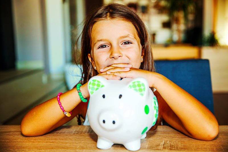 A little girl with her piggy bank